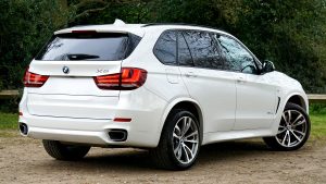 A white luxury SUV parked outdoors, showcasing elegant design and powerful features.
